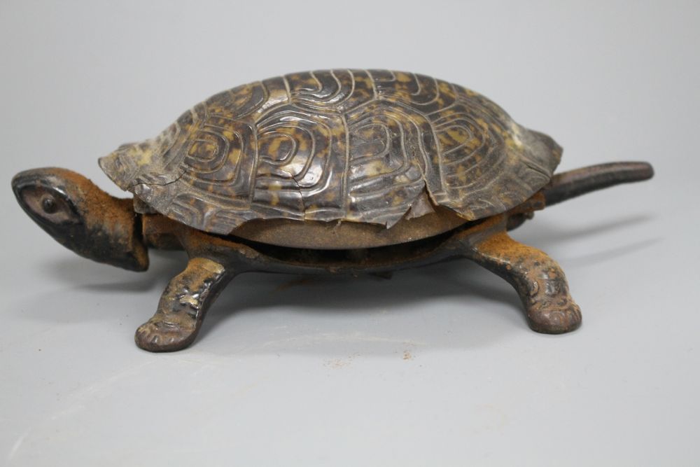 A Victorian cast iron and simulated tortoiseshell table bell, modelled as a tortoise, length 17cm
